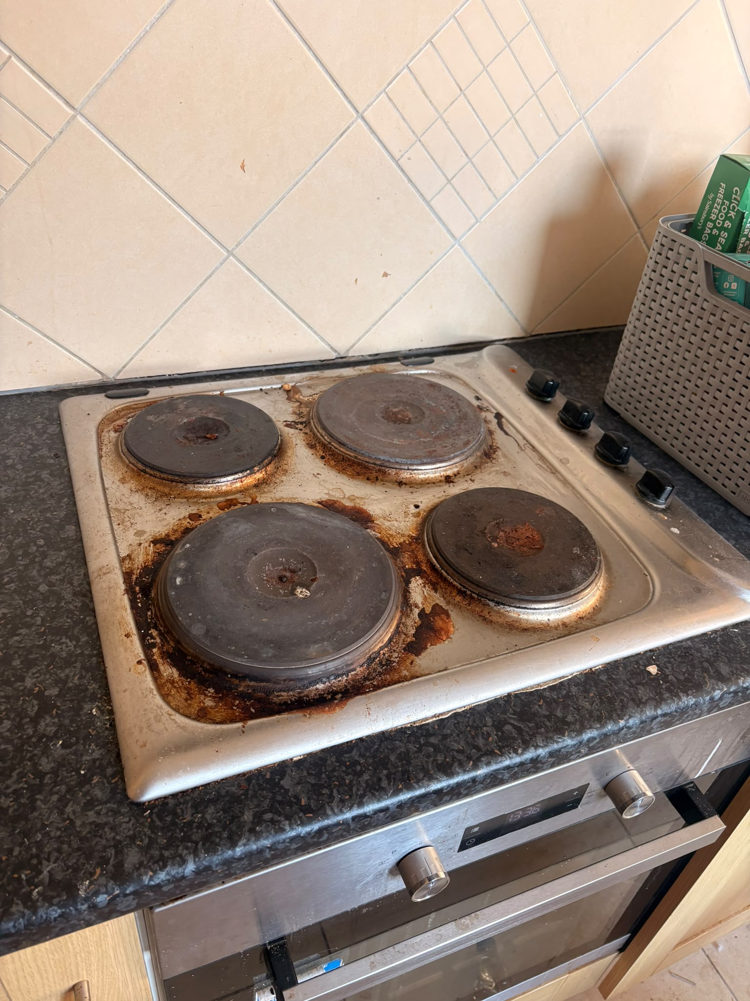 A grimy electric hob before cleaning